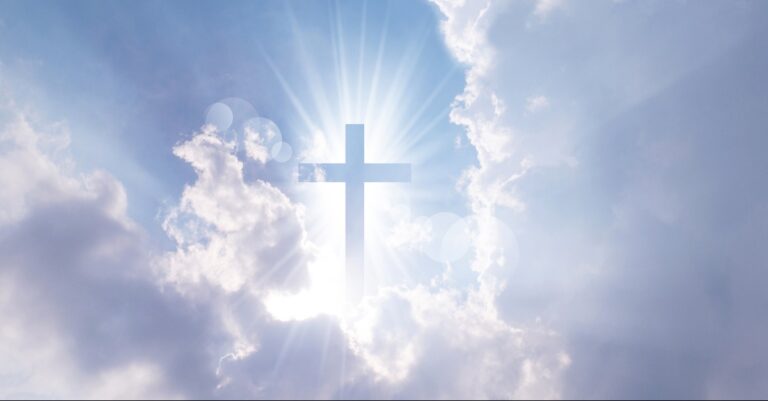 Christian cross appears bright in the sky background